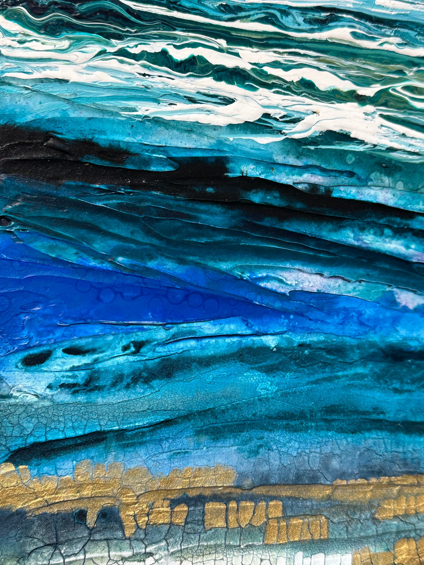 Close-up of a textured surface with blue, white, and gold colors