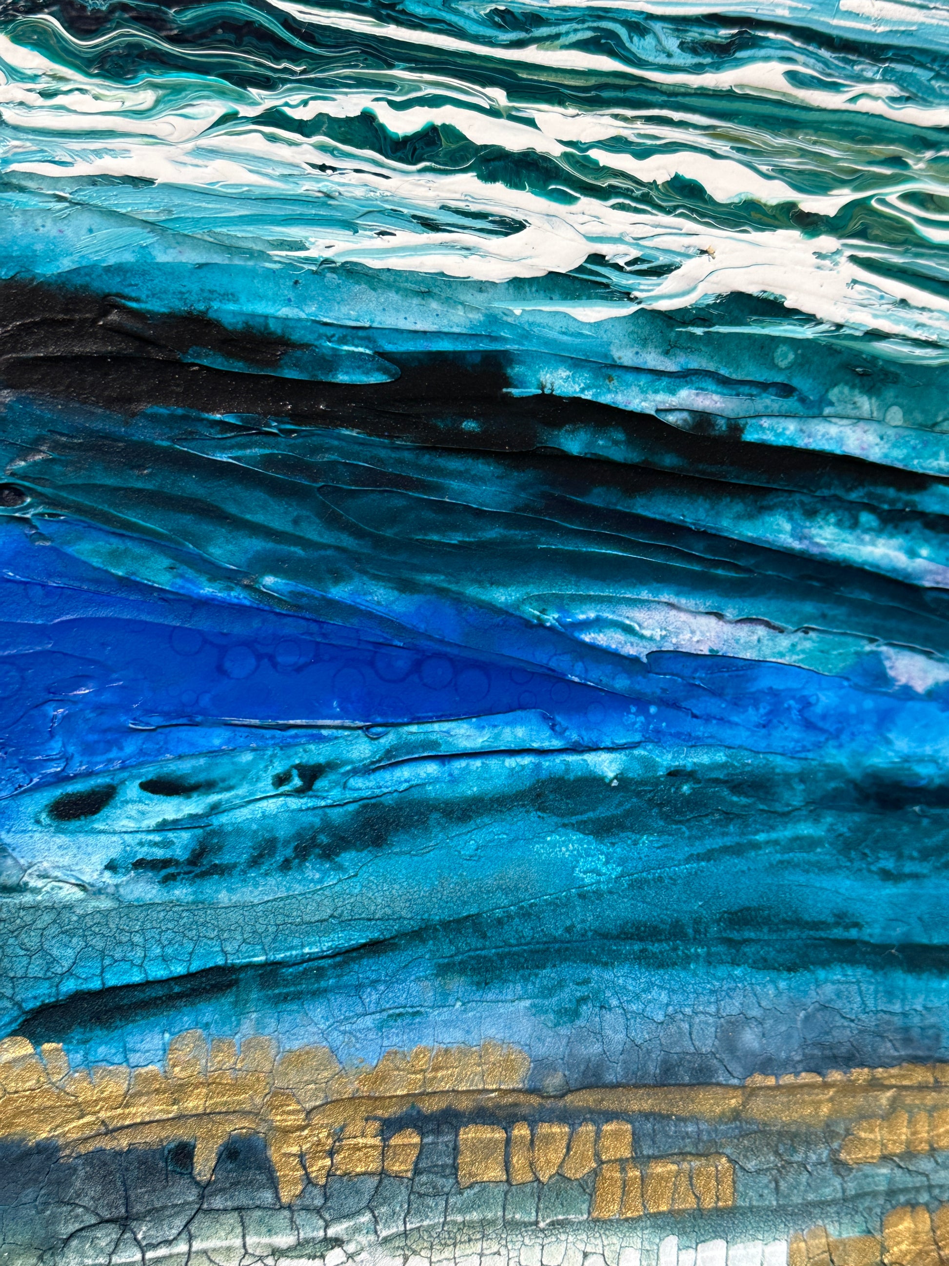 Close-up of a textured surface with blue, white, and gold colors